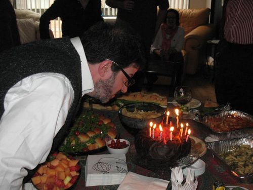 JOhn Hamilton in one of several attempts to blow out the candles on his birthday cake