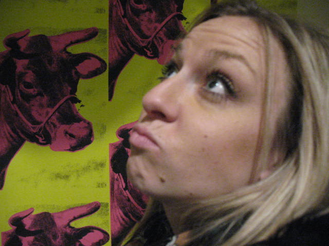 Corinne with Warhol's Cow wallpaper.